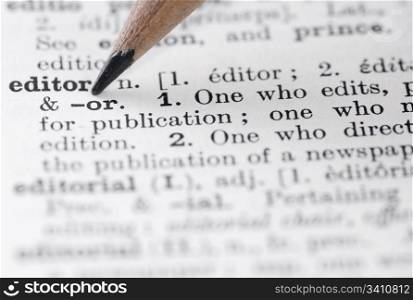 Editor in English Dictionary.. Shallow DOF, focus on editor and nib of pencil.