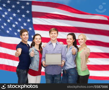 education, advertisement and new technology concept - smiling students with laptop computer blank screen showing thumbs up