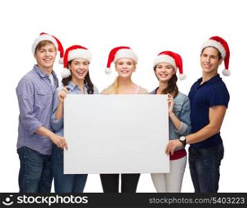 education, advertisement, sale, christmas and people concept - group of smiling students in santa helper hats with blank white board