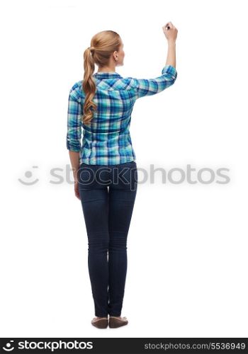 education and advertising concept - young woman from the back writing something in the air