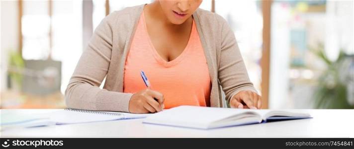 education and business concept - african american female student with notebook over school or office background. african american female student with notebook