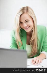 education and business concept - picture of smiling student or businesswoman with laptop in office