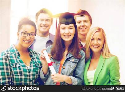 education and competition concept - girl in graduation cap with certificate and students. girl in graduation cap with certificate