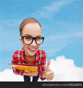 education and gesture concept - smiling student in black eyeglasses with folders showing thumbs up