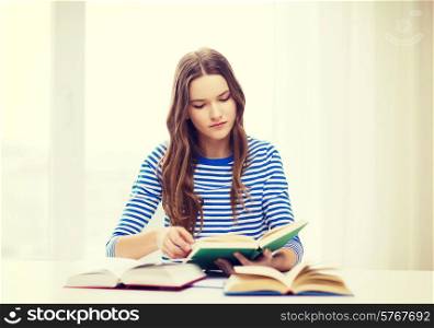 education and home concept - concecntrated student girl with books