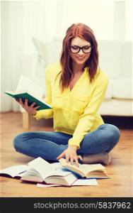 education and home concept - smiling student girl in eyeglasses reading books at home