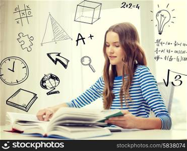education and home concept - smiling student girl sitting at table and reading books