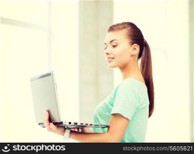 education and internet concept - smiling student girl with laptop at school