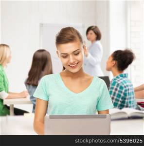 education and internet concept - student with laptop at school