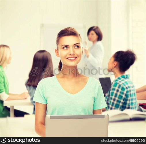 education and internet concept - student with laptop at school