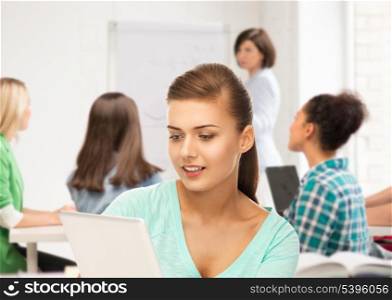 education and internet concept - student with tablet pc in college