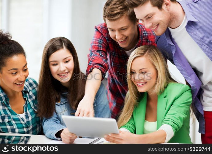 education and internet - smiling students looking at tablet pc in lecture at school