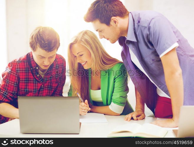 education and internet - smiling students writing test or exam in lecture at school. students writing test or exam in lecture at school