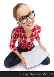 education and leisure concept - smiling teenage girl in black eyeglasses reading book