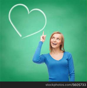 education and love concept - attractive young woman in casual clothes pointing her finger up