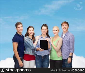 education and modern technology concept - smiling students showing blank tablet pc computer screen over blue sky background