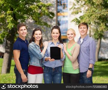 education and modern technology concept - smiling students showing blank tablet pc computer screen