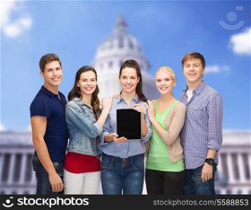 education and modern technology concept - smiling students showing blank tablet pc computer screen