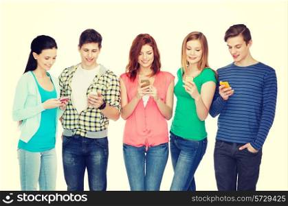 education and modern technology concept - smiling students with smartphones