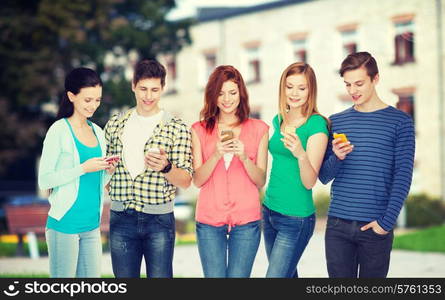 education and modern technology concept - smiling students with smartphones