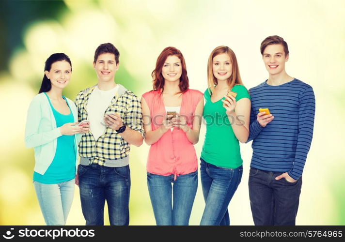 education and modern technology concept - smiling students with smartphones