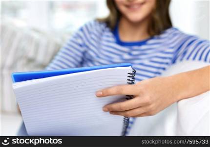 education and people concept - close up of student girl with exercise book. close up of student girl with exercise book