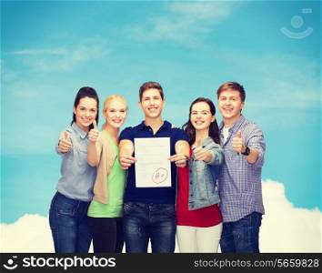 education and people concept - group of smiling students standing and showing test and thumbs up over blue sky background