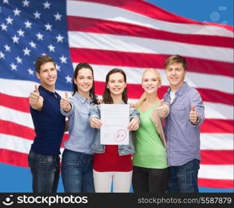 education and people concept - group of smiling students standing and showing test and thumbs up