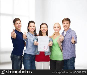 education and people concept - group of smiling students standing and showing test and thumbs up
