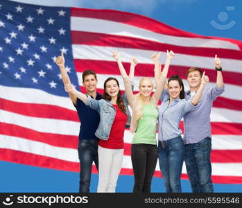 education and people concept - group of smiling students standing and showing thumbs up