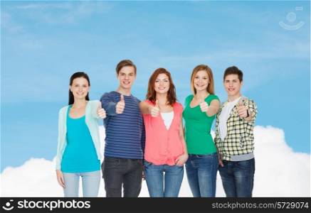 education and people concept - group of smiling students standing and showing thumbs up