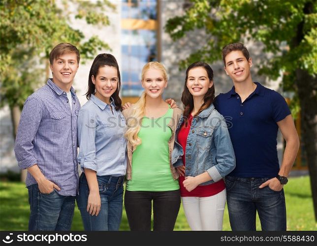 education and people concept - group of standing smiling students