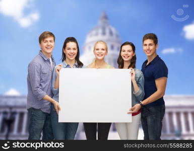 education and people concept - group of standing smiling students with white blank board