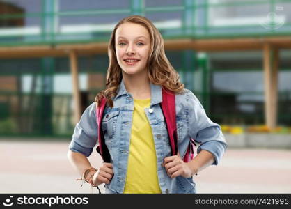 education and people concept - happy smiling teenage student girl with bag over school yard background. happy smiling teenage student girl with school bag