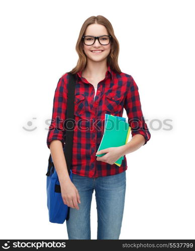 education and people concept - smiling female student in eyeglasses with laptop bag and notebooks