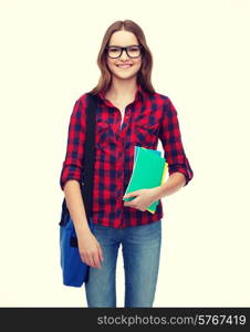 education and people concept - smiling female student in eyeglasses with laptop bag and notebooks