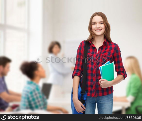 education and people concept - smiling female student with laptop bag and notebooks