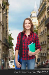 education and people concept - smiling female student with laptop bag and notebooks