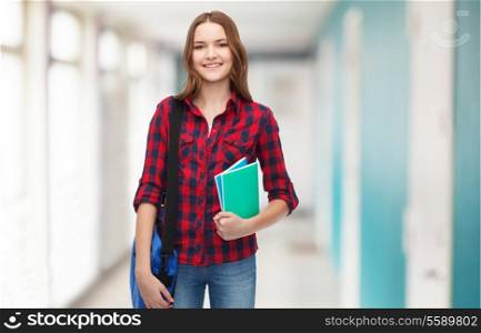 education and people concept - smiling female student with laptop bag and notebooks