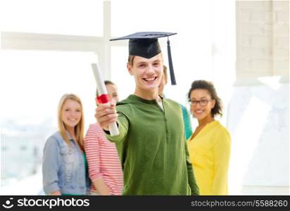 education and people concept - smiling male student with diploma and corner-cap and friends on the back