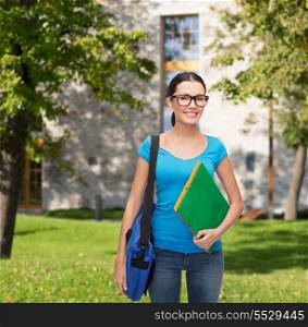 education and people concept - smiling student in eyeglasses with bag and folders standing
