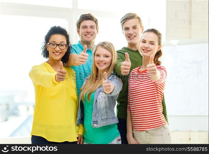 education and school concept - five smiling showing thumbs up at school