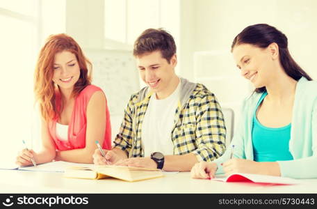 education and school concept - five smiling students with textbooks and books at school