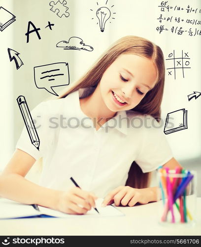 education and school concept - little student girl drawing at school