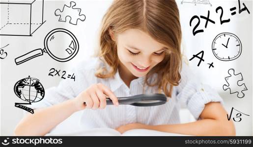 education and school concept - little student girl reading book with magnifier at school. girl reading book with magnifier at school