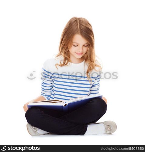 education and school concept - little student girl studying and reading book