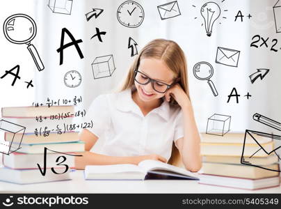 education and school concept - little student girl studying and reading books at school