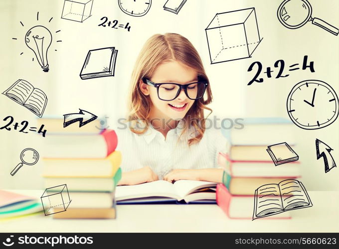 education and school concept - little student girl studying and reading books at school