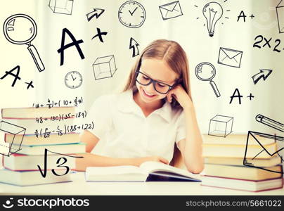 education and school concept - little student girl studying and reading books at school