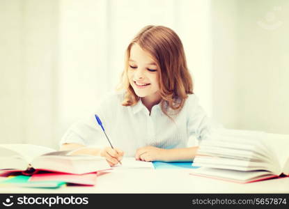 education and school concept - little student girl studying at school